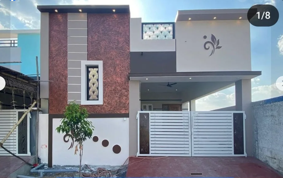 Single-level home with a covered entrance porch, red textured facade panels and geometric screens.