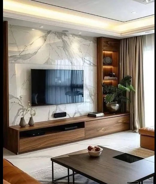 Living-room television wall with veined panels, warm-toned cabinetry and lit display niches.