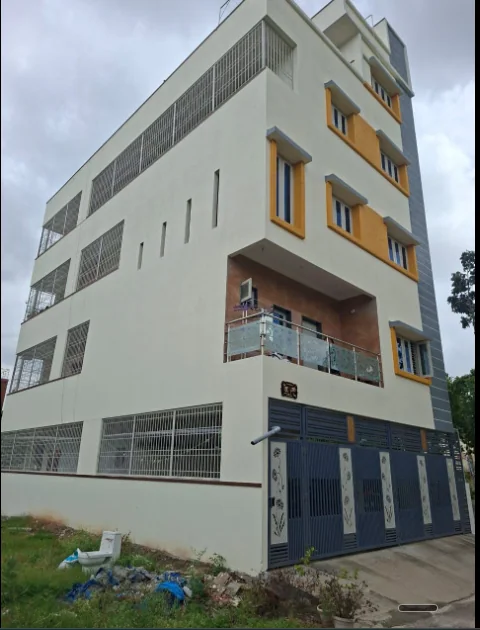 Multi-level white corner residence with ochre window surrounds and recessed balconies.