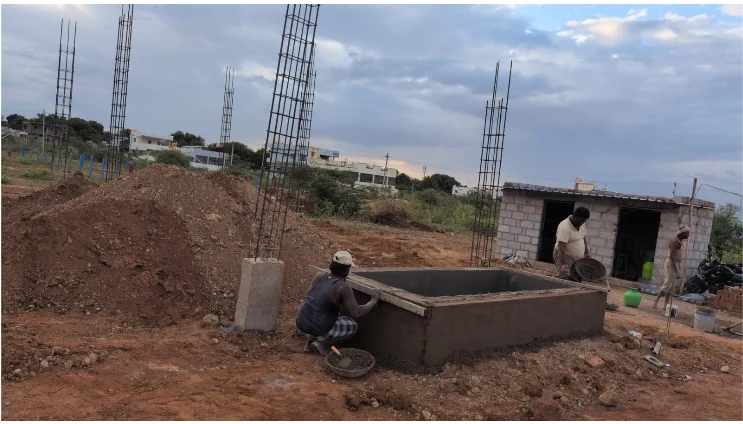 KSR House Contractors ongoing site with reinforced column cages and ground-level structural work