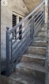 Concrete staircase with metal railing during ongoing KSR House Contractors construction work